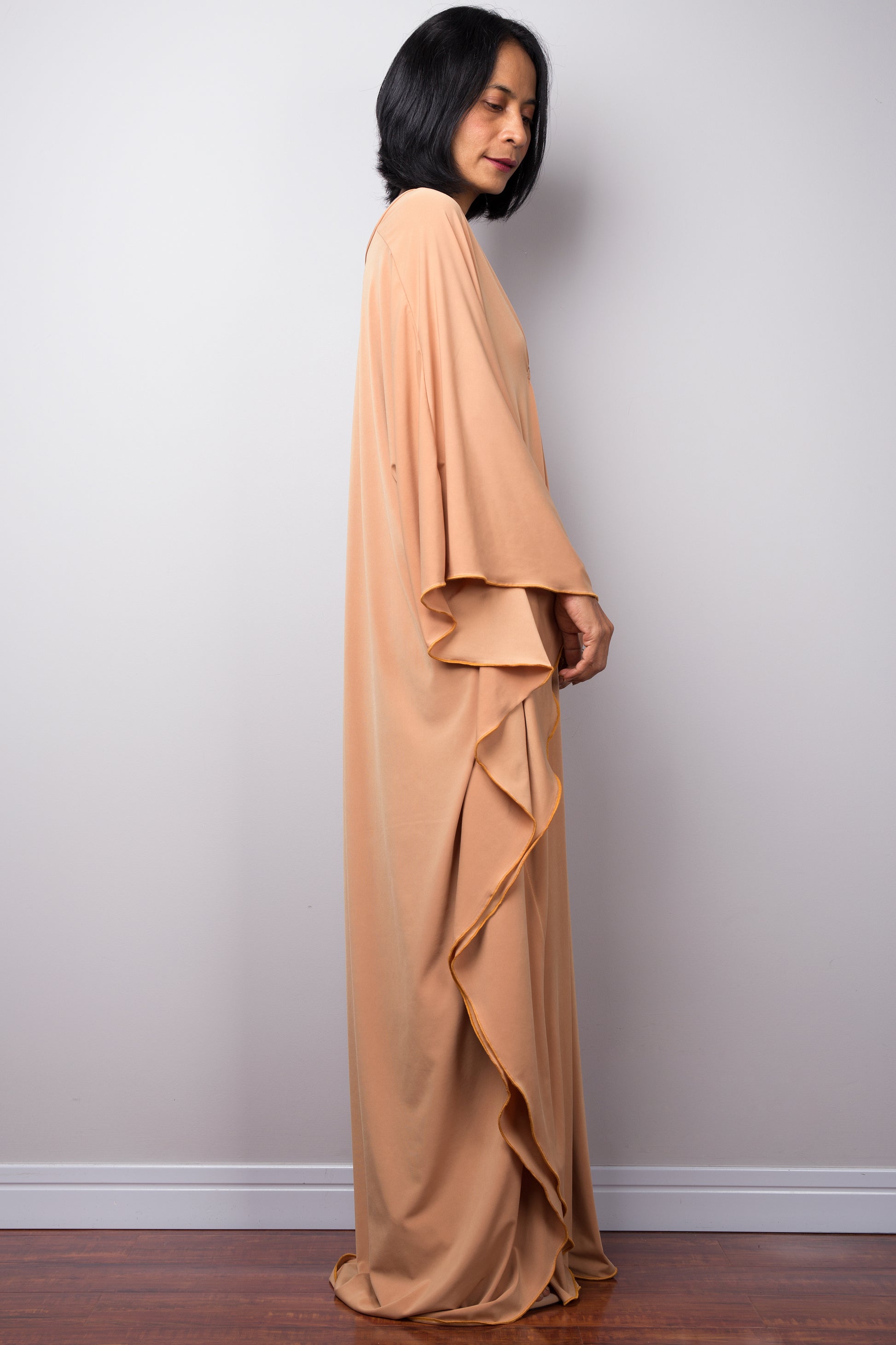 Long kaftan dress by Nuichan. V neck and woven detail on the chest. Side view
