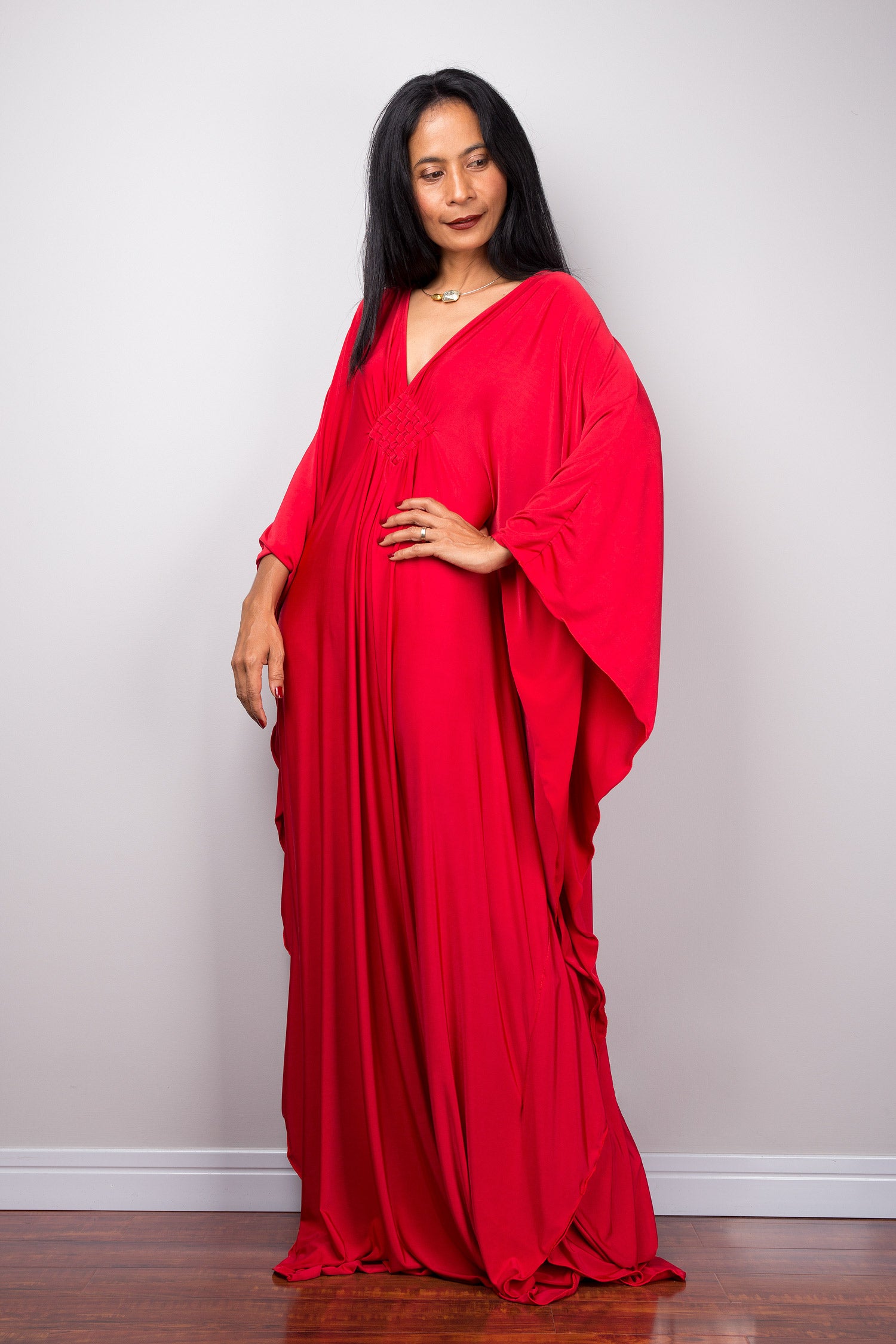 Long red kaftan dress with v neck and braided diamond detail on chest