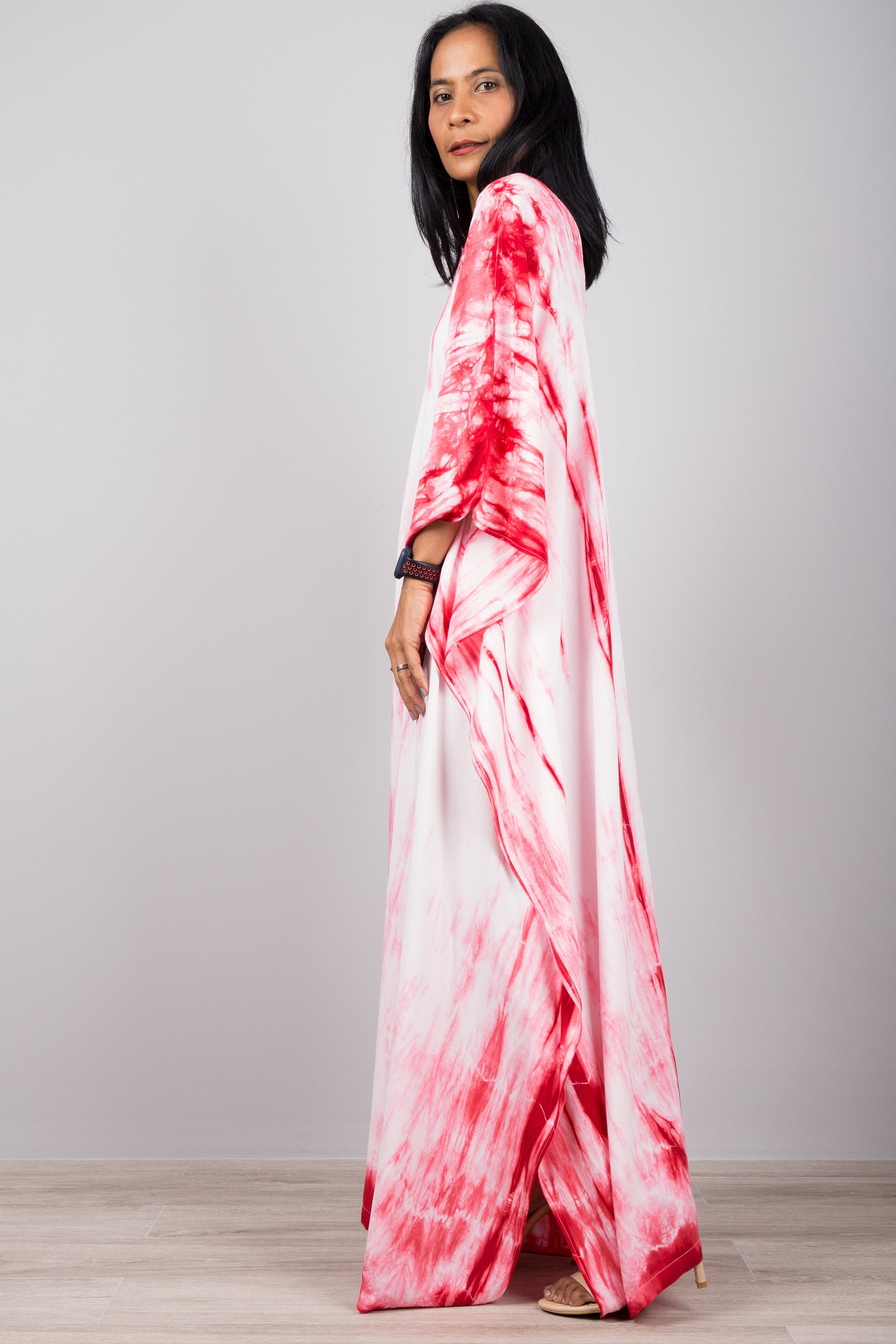 Red and white shibori kaftan dress. Side view