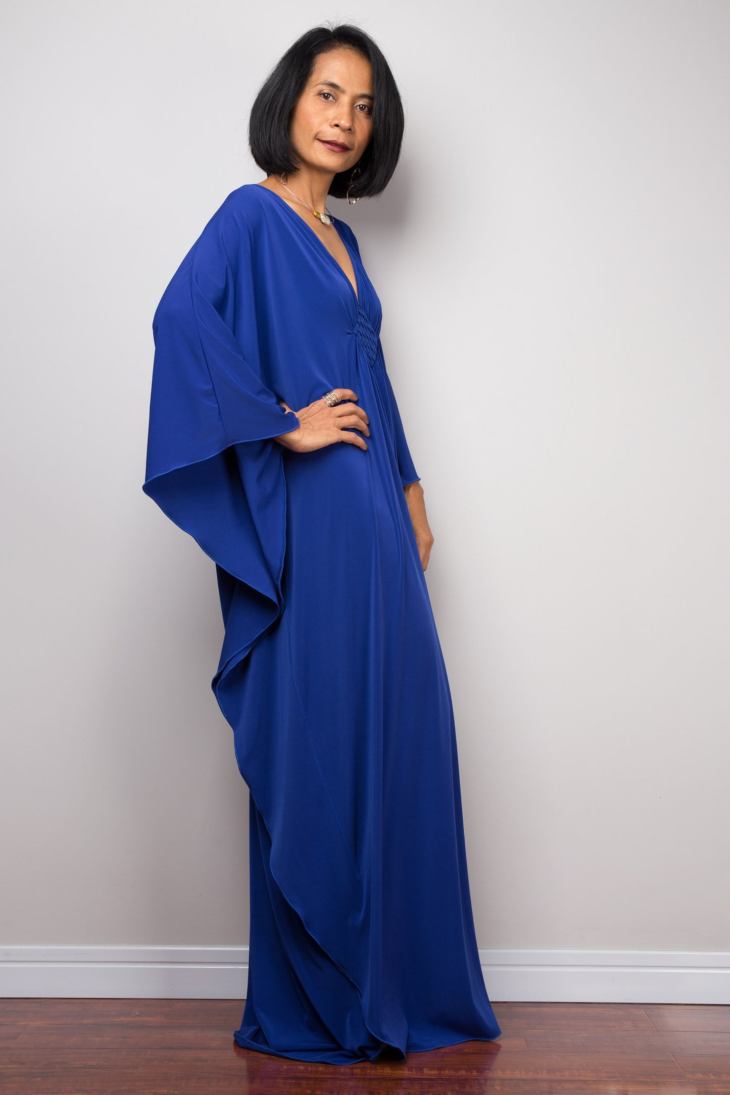 Large blue kaftan dress with v neck and braided chest detail. Side view