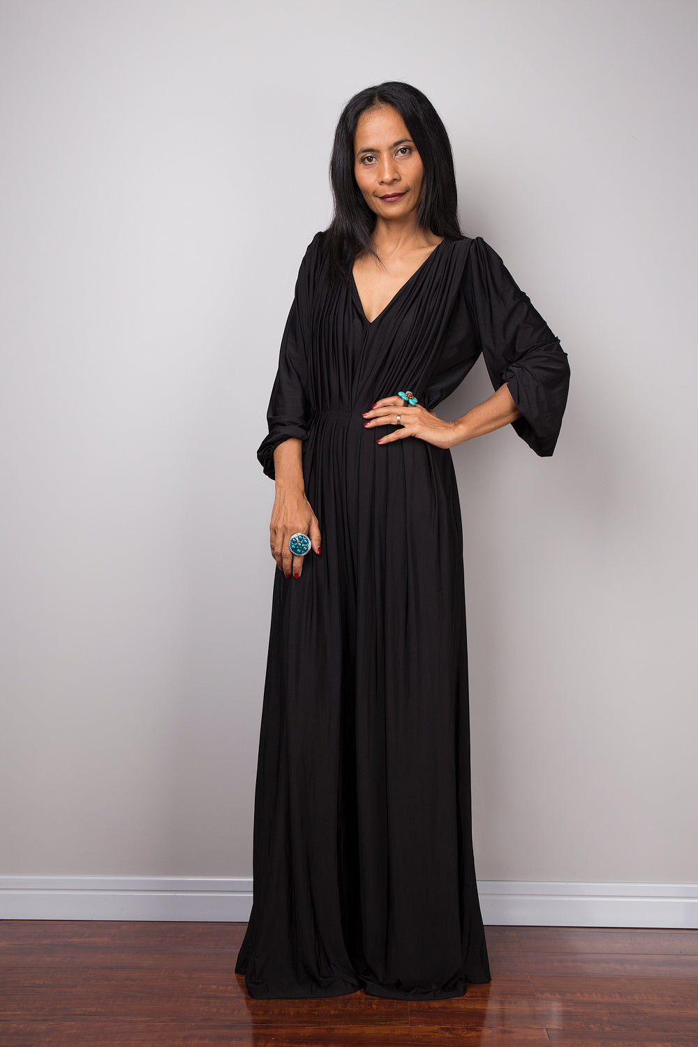 Black jumpsuit with high waist and plunging neckline.  Long sleeved pleated black jumper.