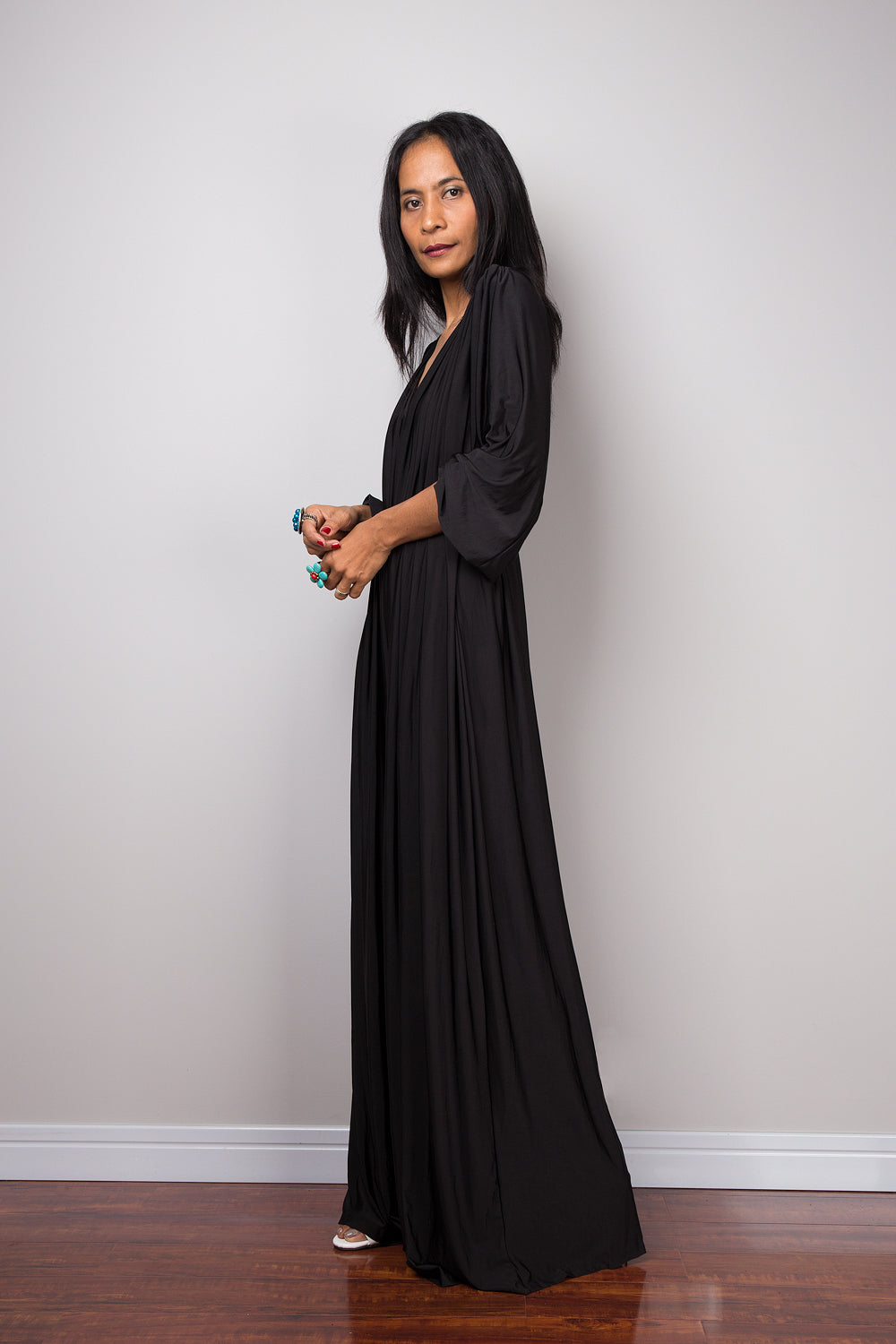 Black jumpsuit with high waist and plunging neckline.  Long sleeved pleated black jumper.