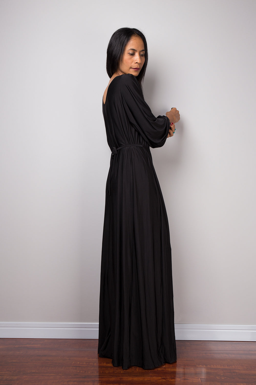 Black jumpsuit with high waist and plunging neckline.  Long sleeved pleated black jumper.