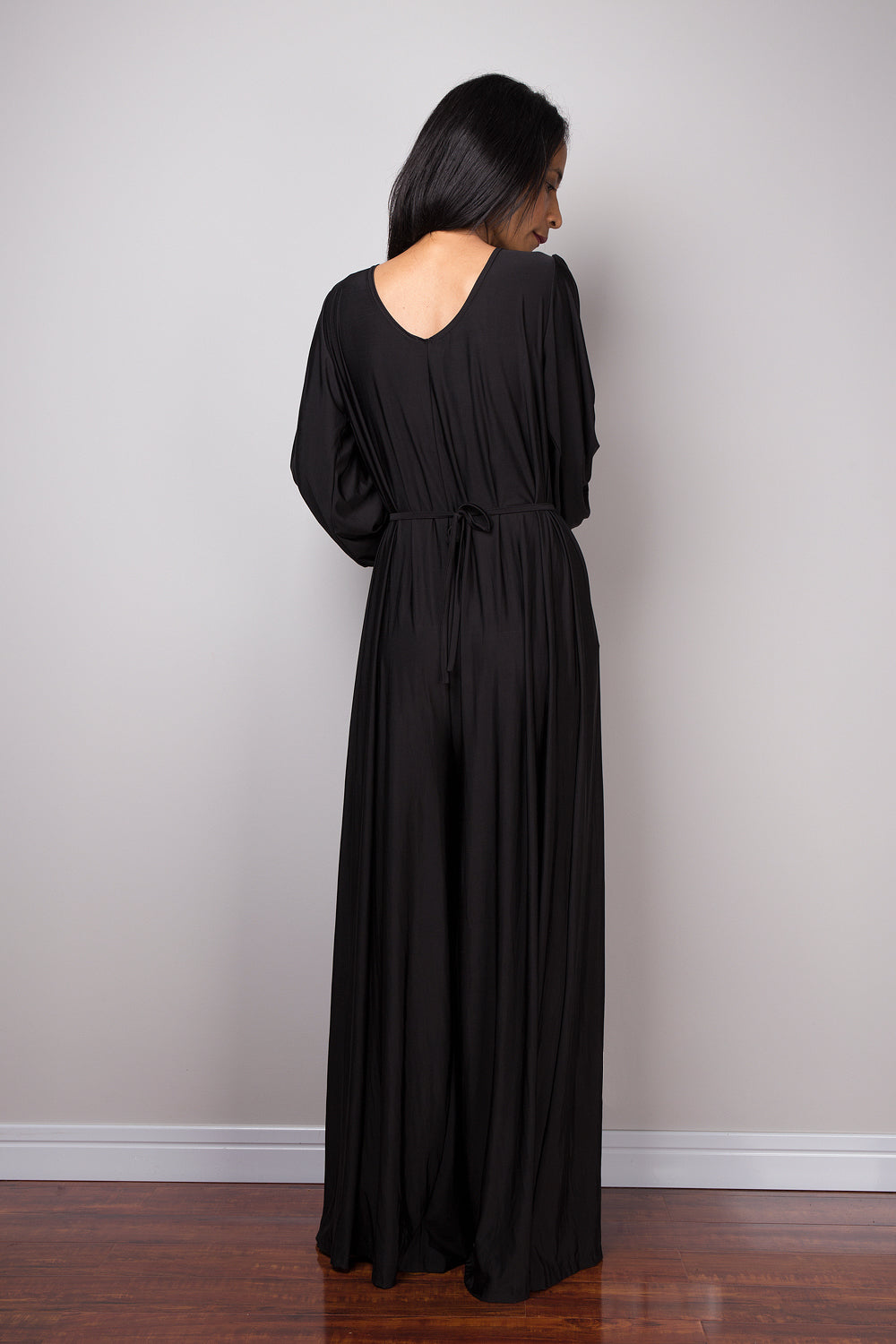 Black jumpsuit with high waist and plunging neckline.  Long sleeved pleated black jumper.