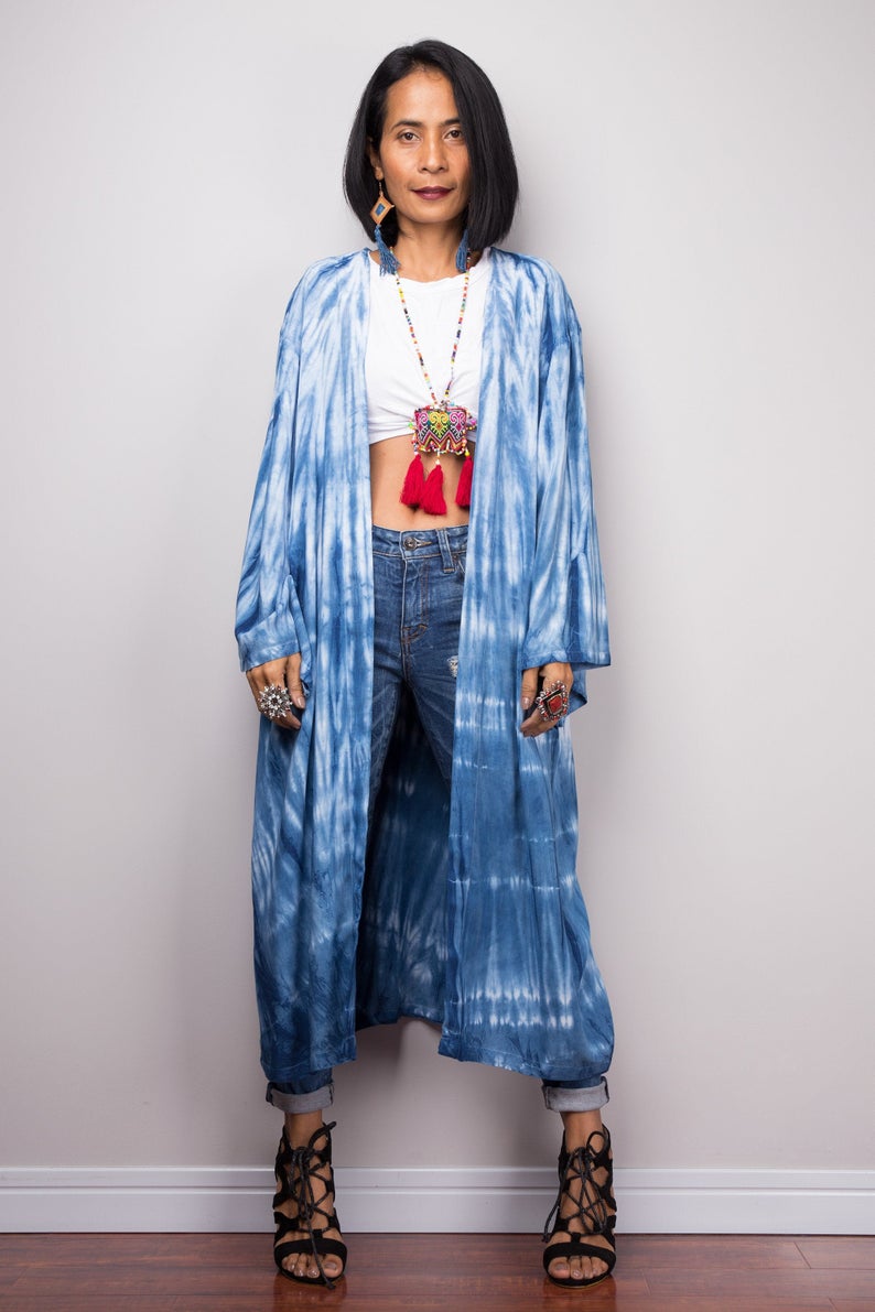 Woman wearing natural indigo shibori tie-dye open front cardigan with pockets.  Front view