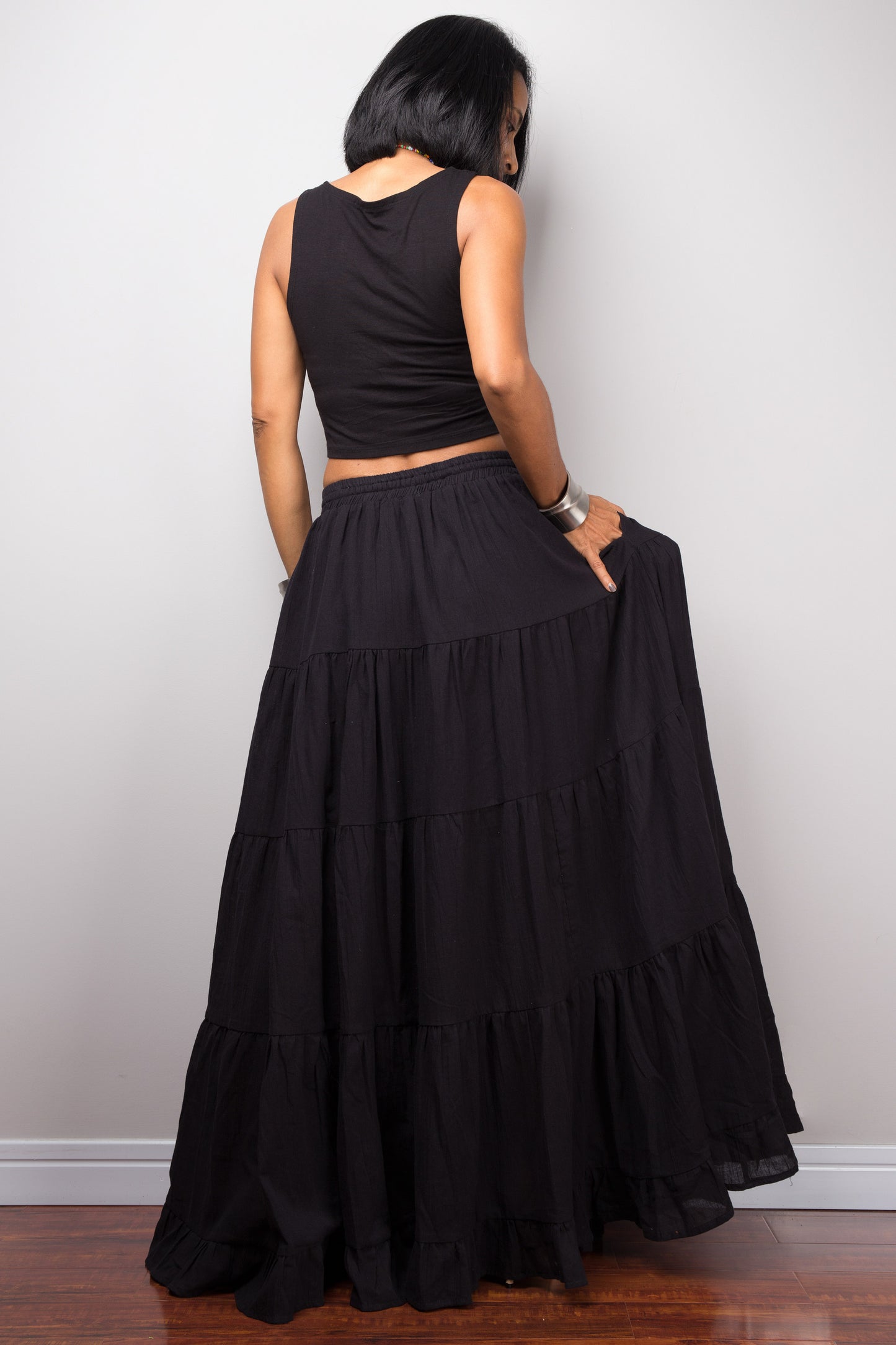 Black long cotton maxi skirt by Nuichan. Back view