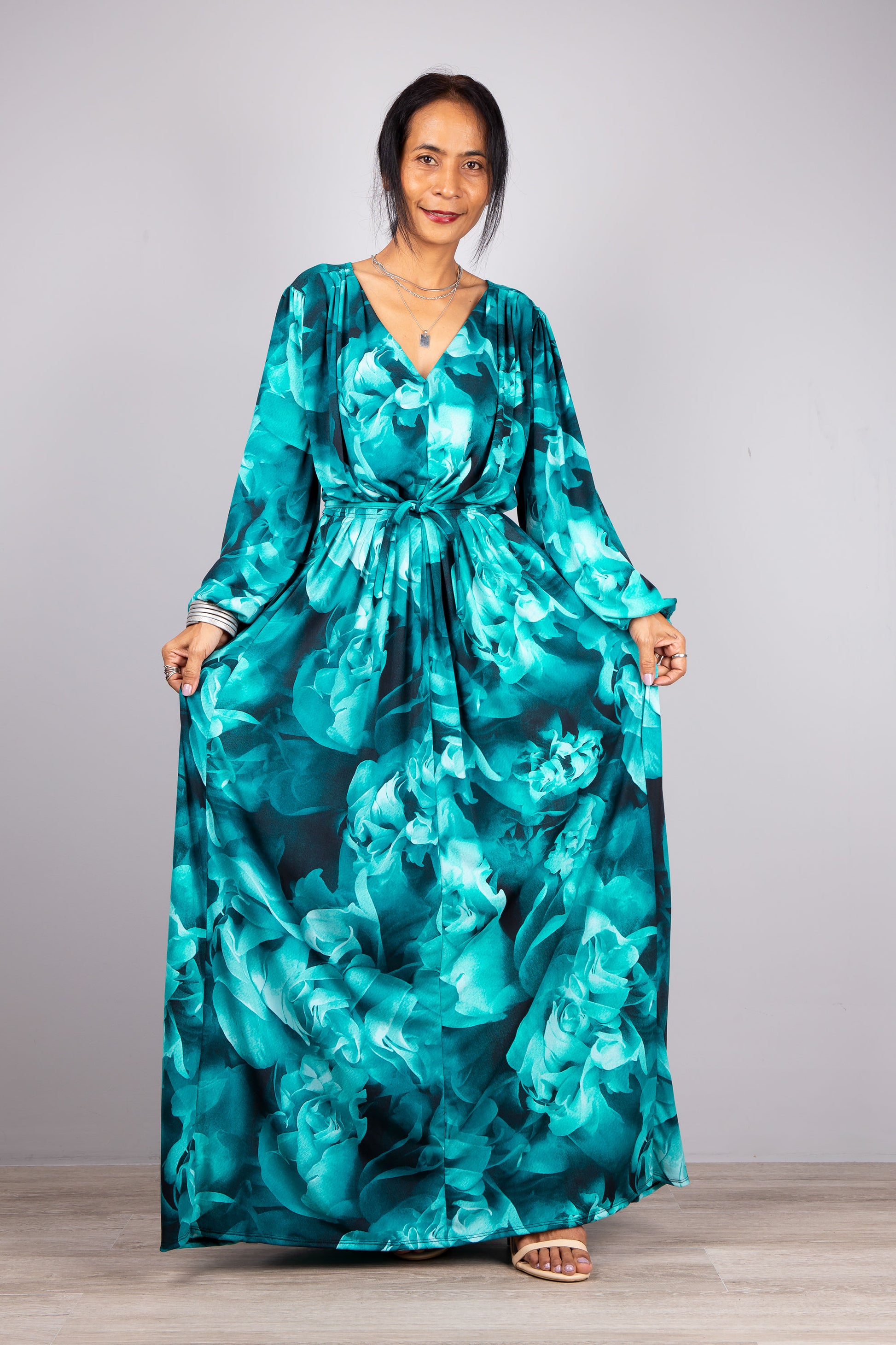 A Boho Moment: Our model poses in the Boho Chic Long Sleeve Maxi Dress, the light grey background highlighting the dress's vibrant color and flowing form, inviting all to embrace the bohemian lifestyle.