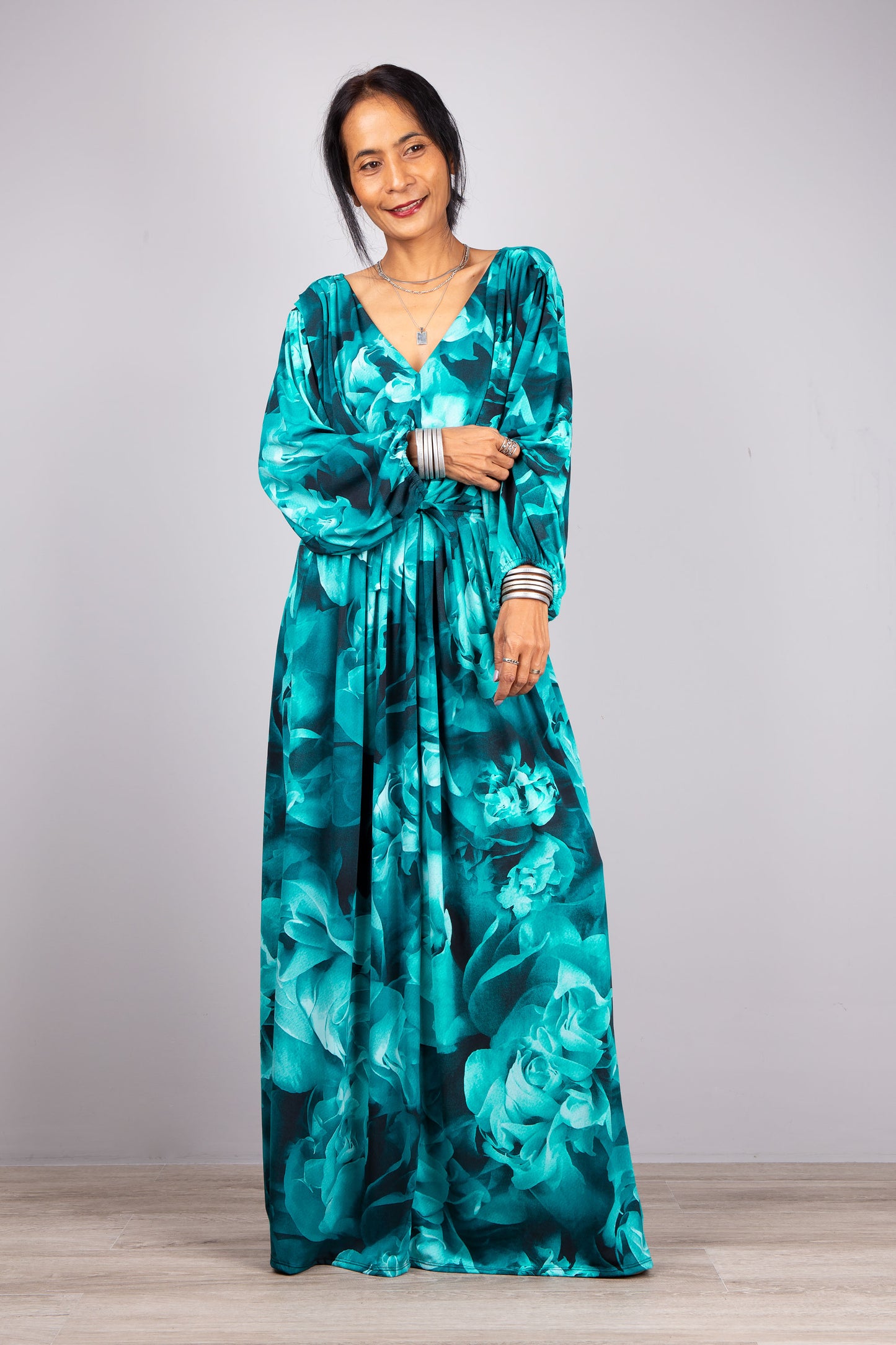 Vibrant Boho Elegance: Against a subtle grey canvas, our model dons the vibrant turquoise Boho Chic Long Sleeve Maxi Dress, perfect for those who love to make a statement.